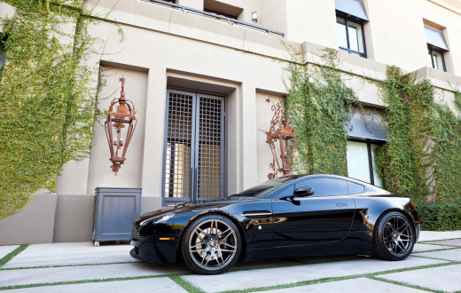 Scottsdale, United States - November 3, 2011: A photo of a parked Aston Martin Vantage sports car with custom wheels. Every Aston Martin is hand built in England.