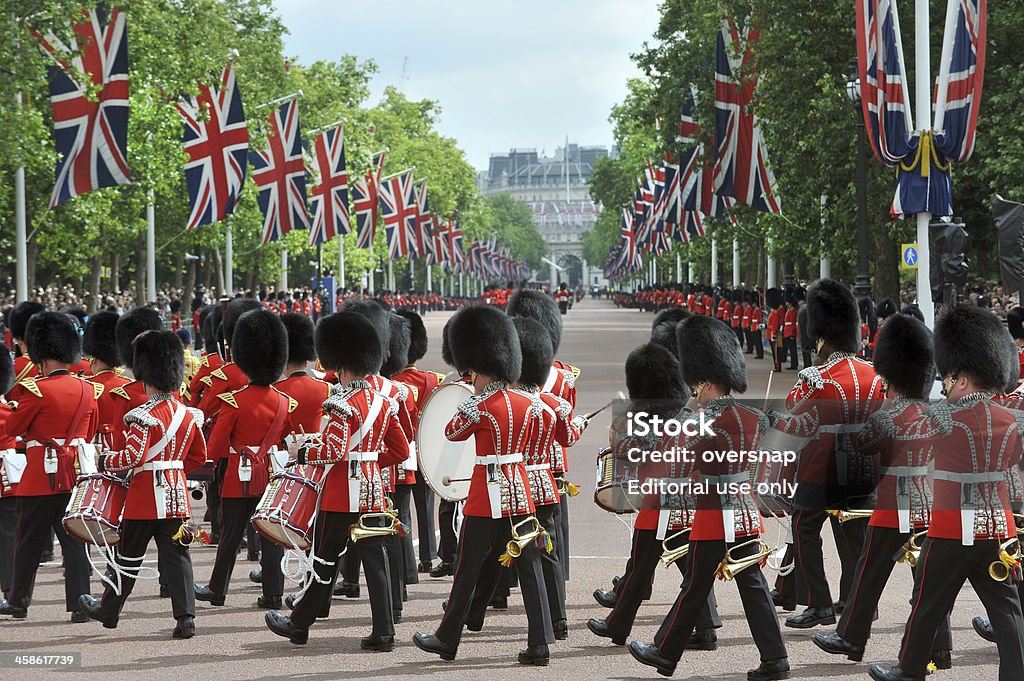 London bandsmen London, UK - June 13th, 2009: A military guards band marches under british flags down the Mall in London near Buckingham Palace as part of the annual Trooping the Colour ceremony on the Queen\'s birthday Trooping the Color Stock Photo