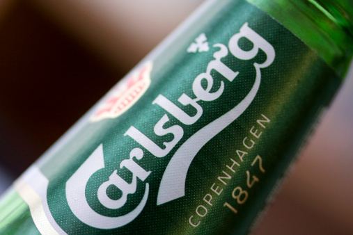 Picture of a can with the sprite logo taken on a fridge in a street. Also known as Coke, it is a carbonated soft drink manufactured by The Coca-Cola Company