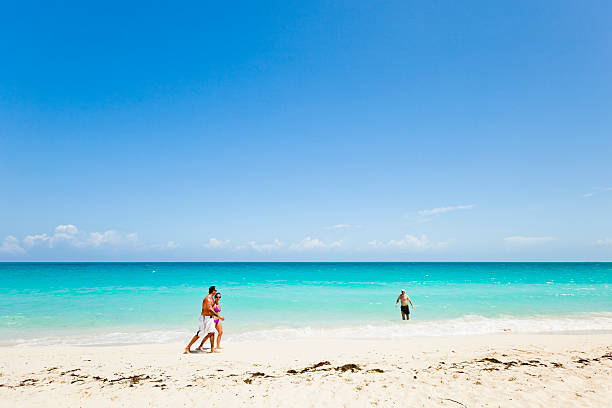 Caro Santa Maria, Cuba - April 7, 2011: Some tourists walking on the beach of Melia Las Dunas All Inclusive Resort at Cayo Santa Maria in Cuba.