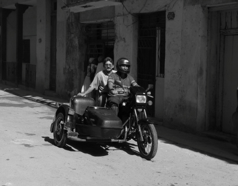 Havana, Cuba - January 13, 2006: Two cuban men driving on old 