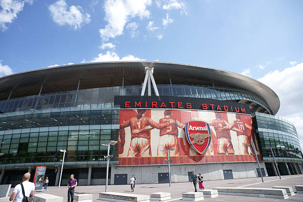London, United Kingdom - July, 5th 2010: Few tourists walking by Emirates stadium in London, home of Arsenal  football club also called gunners.