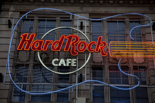 Manchester, UK - August 20, 2011: Hard Rock Cafe neon sign and logo. Hard Rock Cafe is a chain of theme restaurants founded in 1971 and now owned by the Seminole tribe of Florida.