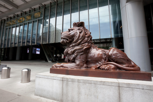 Hong Kong, China - August 12, 2011: The lion statue is in front of the HSBC headquarters building. This building is located in 1 Queen\'s Road Central, Central District, Hong Kong. This building was designed by Norman Foster.