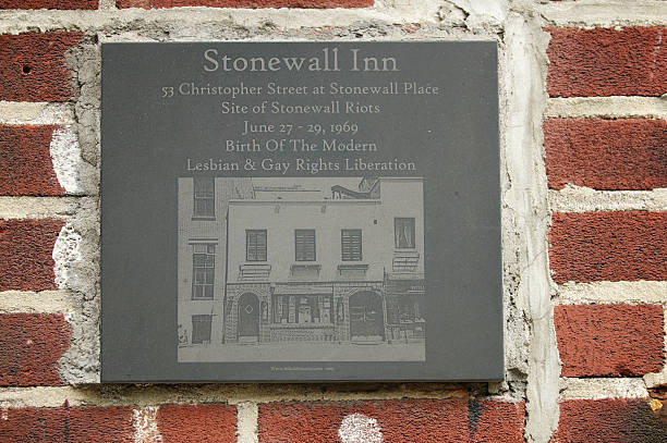 New York City, USA - August 26, 2011: Memorial plaque for the Stonewall Inn on Christopher Street. The bar was the site of the Stonewall riots of 1969, a catalyst for the gay liberation movement and the modern fight for gay and lesbian rights in the United States. The Inn was designated a National Historic Landmark in 2000.