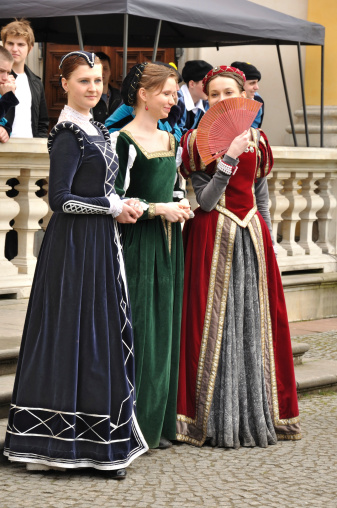 Warsaw, Poland - May, 2nd 2010: Three amateur actresses in renaissance costumes in front of Wilanow Palace during a May picnic