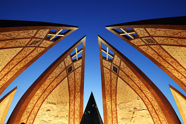 Islamabad, Pakistan - June 12, 2010: The Pakistan Monument, inaugurated on 23rd March, 2007, is a national monument representing the nation's four provinces and three territories is designed by Arif Masoud. Built over Shakar Parian Hills, the structure comprises four blossoming flower petals, built of granite, representing the story of Pakistan and unity of Pakistani people. The inner walls of the petals are decorated with murals decorated by a team of artists led by Kausar Jahan and Zarar Haider Babri.