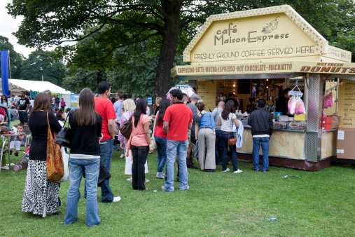 Edinburgh, Scotland, UK - 8th August 2010:People queuing up for hot drinks and snacks being sold from a booth/kiosk/trailer during the Edinburgh Mela - a multicultural arts festival held on Leith Links.