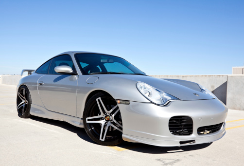 Scottsdale, United States - November 17, 2011: A photo of a parked silver 2002 Porsche Carerra. The Carerra from Porsche is known for its independent rear suspension and rear engine.