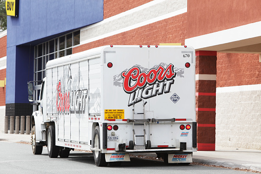 Charlottesville, Virginia, USA - March 8, 2011: A Coors Light beer delivery truck is parked near the entrance to a Best Buy retail store in Charlottesville, Virginia.