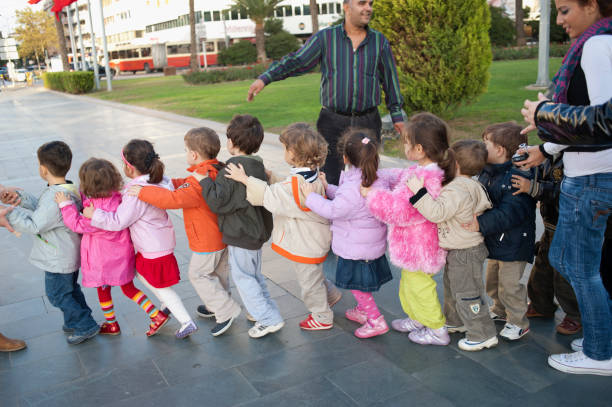 Visiting Atatürk's Memorial Izmir, Turkey - November 10, 2010:Turkish little children visiting the memorial of AtatArk in Alsancak with their teachers, at the deathday of AtatArk 10 November in Cumhuriyet Square. primary school assembly stock pictures, royalty-free photos & images