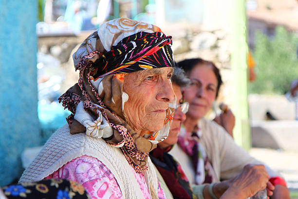 a women with breton headdress on a harbor