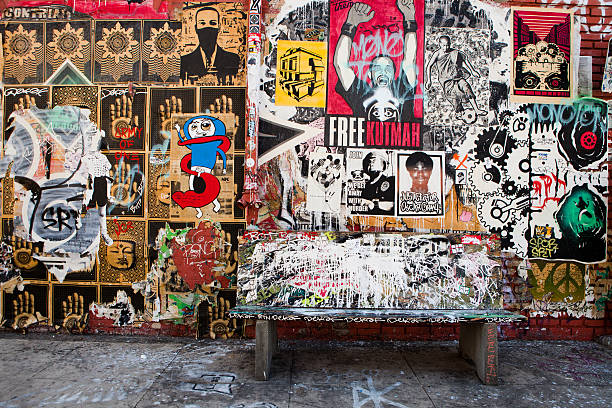 Los Angeles, California, USA - July 1, 2010:  Graffiti, wheat paste art, stencil art, and other types of street art cover a wall in Los Angeles, California.  Street art is prevalent in Los Angeles, being one of the largest cities in the world where artists can share their work with the public.