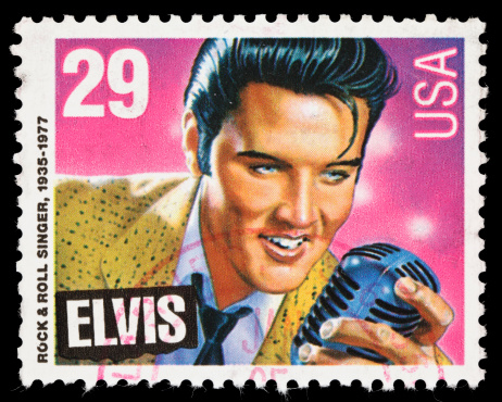 Sacramento, California, USA - December 25, 2010: A 1993 USA postage stamp with an illustration of Elvis Presley holding a microphone. The stamp illustraton of \