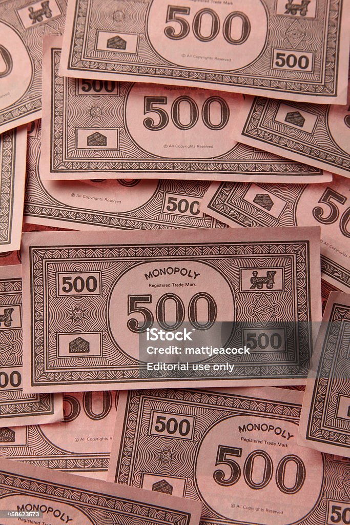 Monopoly game money London, United Kingdom - August 4, 2011: Monopoly game money. Monopoly is a board game named after the concept of dominating a market, a monopoly. Players take turns to move around a board buying property and paying and receiving rent. Arts Culture and Entertainment Stock Photo