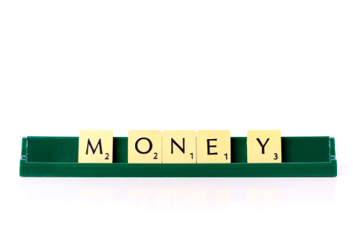 Izmir, Turkey - November 10, 2011: Money word with scrabble letters.  Scrabble was created in 1938 . It is popular world wide and has sold over one hundred and fifty million sets