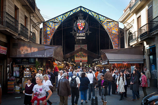 Barcelona, Spain- November 11, 2011: Main entrance from the Ramblas to La Boqueria Market in Barcelona. The Mercat de Sant Josep de la Boqueria, often simply referred to as La Boqueria, is a large public market in the center of Barcelona and one of the city's foremost tourist landmarks, known for its diverse selection of goods.