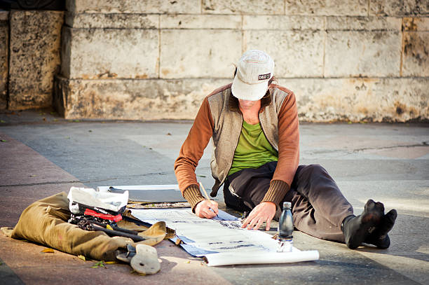 Havana, Cuba - January 1, 2011: Artist painting right at Paseo Del Prado in  La Havana - a famous boulevard in the central district of the city where souvenirs and paintings are sold