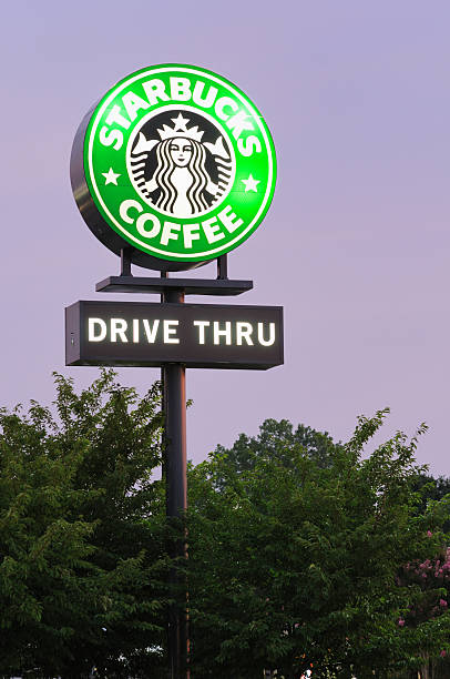 Huntsville, Alabama, USA - July 20, 2011: Starbucks coffee and drive thru sign illuminated at dusk. Sign located near the corner of Mastin Lake Road and North Memorial Parkway in Huntsville, Alabama.