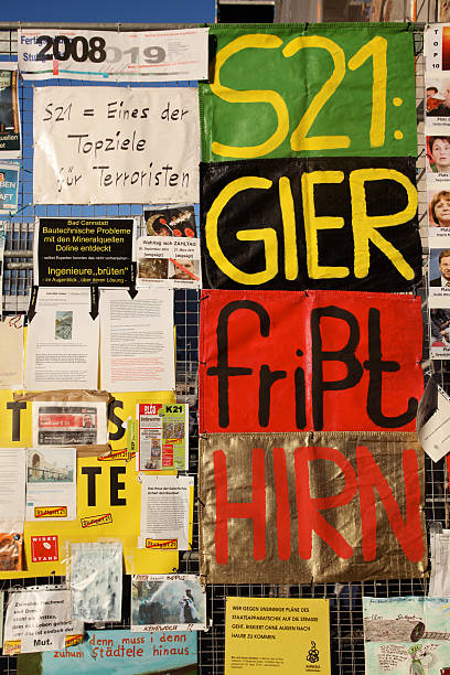 S21 protest messages on the construction fence Stuttgart, Germany - March 7, 2011: Protest against the planned new railway station S21. This image shows the construction fence directly at the gate to the railway station. german free democratic party photos stock pictures, royalty-free photos & images