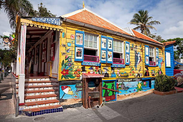 Philipsburg, St Maarten, Netherlands - March 10, 2011: The L'Escargot Restaurant on Front Street is a local landmark. The decoration of the 150 year old Creole Gingerbread house includes Toulouse Lautrec style murals.