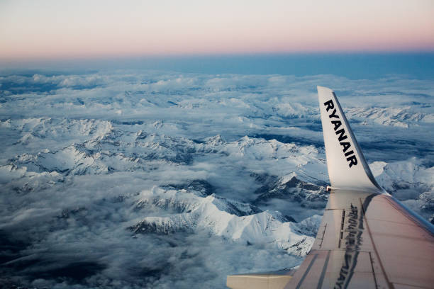 Luzern, Switzerland - February 28, 2010: Winglet left wing of a Boeing during the Ryanair flight from Milan to London. In the background the mountains of the Italian-Swiss Alps border.