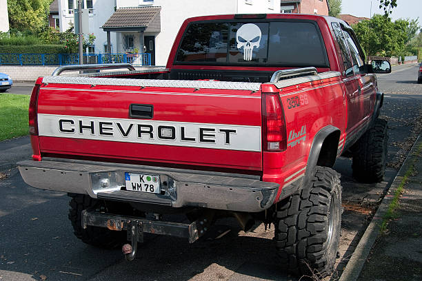 Cologne, Germany - August 23, 2011: Back-view of a red monster truck , an american Chevrolet Pick - Up with four-wheel drive , also used for off road terrain and seen in the streets of Cologne , Germany.