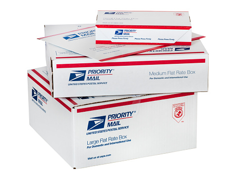 Los Altos, California, USA - November 1, 2011:  A stack of United States Post Office Priority Mail Flat Rate envelope and boxes.  These Post Office packaging items are free, with a flat pre-defined postal fee charged when actually mailing them.  These can be used to package and mail different sized items domestically or internationally.