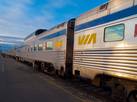 Edmonton, Canada - October 31, 2008: VIA Rail train waiting at the platform in Edmonton, Alberta - people can be seen walking towards their carriage in the distance.