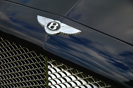 Eindhoven, The Netherlands - August 29, 2004: Bentley logo and grille on a dark blue Bentley Arnage R limousine.