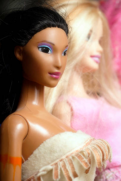 Two pair of toy dolls legs going to each other on white background. Different skin tones and races. Stop racism. Concept of Diversity and unity, equality with place for text.