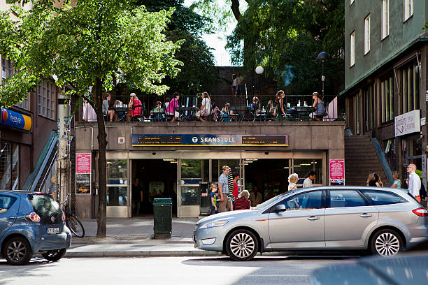 Stockholm, Sweden - June 27, 2011: People at a cafe in Stockholm. Below the cafe is the Skanstull subway station entrance. The street in front is Gotgatan.