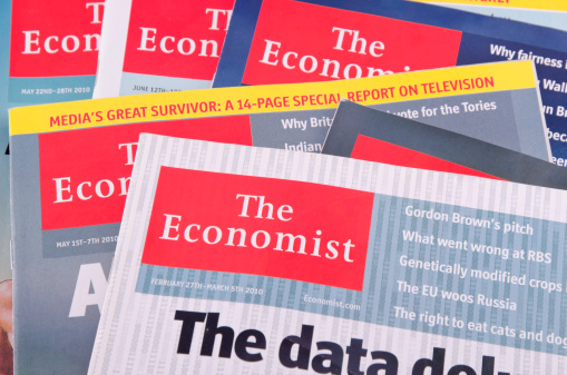 Haarlem, the Netherlands - July 3, 2011: Plenty of The Economist magazines put on top of each other. The Economist is a weekly magazine specialized in international politics and economy. It\\'s based in England and it\\'s one of the most respected magazines in the world.