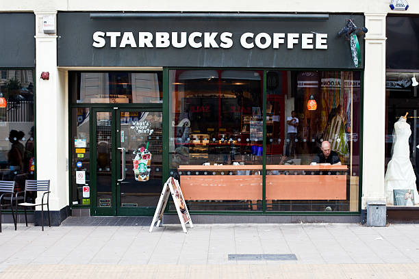 London, United Kingdom - July 6, 2011: People having a break at the Starbucks Coffee located in London. Starbucks Corporation is an international coffee and coffeehouse chain based in Seattle, Washington.