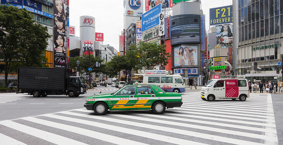 Tokyo, Japan - May 30, 2011: Vehicles cross the intersection at the Shibuya Crossing in front of the Shibuya Station Hachiko exit in the Shibuya Ward of Tokyo.