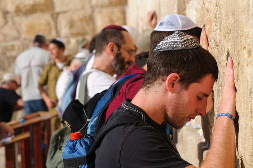Jerusalem, Israel - October 20, 2010: Jewish men pray at the Western Wall. Also called the Wailing Wall, it is the holiest site in Judaism.