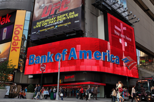 New York, NY, USA - September 17, 2011: Video LED display on the exterior of the Marriott Hotel between 45th and 44th Streets on Broadway in Times Square advertising Bank of America above a bank location. Bank of America  is currently one of the four largest banks in the USA. Billboard adverts dfor Kodak, and UFC (Ultimate Fighting Championship) can also be seen. Shoppers and tourists walk the sidewalks.