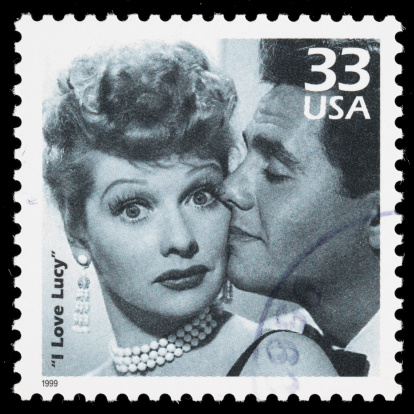 Sacramento, California, USA - March 20, 2011: A 1999 USA postage stamp with a photo of Lucy and Ricky Ricardo (played by Lucille Ball and Desi Arnaz), the main characters in the classic 1950s TV comedy series I Love Lucy. I Love Lucy is a registered trademark of CBS Broadcasting Inc.