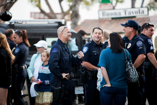San Luis Obispo, CA USA - May 12, 2011: A special appearance with law officers from several local cities at the farmers market in a popular venue that happens every Thursday night in downtown San Luis Obispo, CA. on Higuera St. They were there for National Police Week offering the public information about their resources and what they offer you as a community member. These officers are from the city of Arroyo Grande.