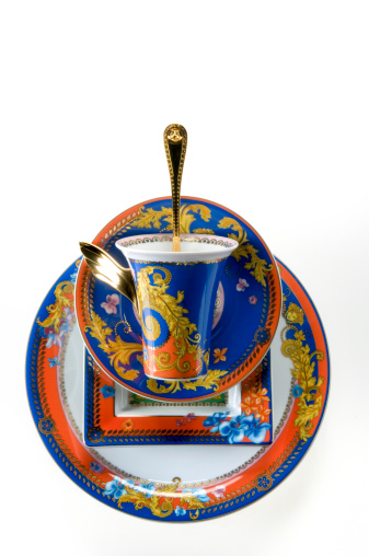 Leiden, The Netherlands - October 11, 2005: Product shot of a china tea cup, saucer, square plate and plate from the Medusa limited edition designed by Gianni Versace on white background. Versace designed several series of china, which are produced by the famous German porcelain factory Rosenthal