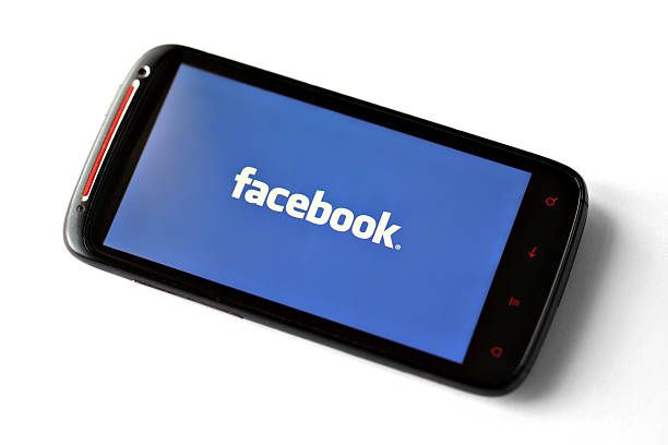 facebook логотип на экране смартфона - web page internet profile e mail стоковые фото и изображения