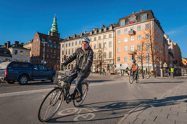 Stockholm cyclists commuting on Sodermalm Stockholm, Sweden - April 5th, 2012: People cycling through Slussen on Sodermalm in the early morning sunshine along Stockholm's extensive network of cycle paths. sodermalm photos stock pictures, royalty-free photos & images