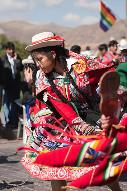 Young Woman Dancing during Cusco Parade Cusco, Peru - June 19, 2010: A young woman wearing an elaborate Peruvian costume performs a Peruvian dance during the day time parades which are part of the week long festivities of the Inti Raymi Festival. The parades are held in Plaza de Armas, Cuscos' main square. inti raymi stock pictures, royalty-free photos & images