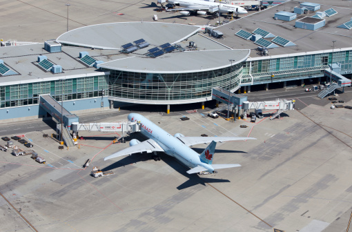 Vancouver, Canada - May 13, 2010: An Air Canada Boeing 777 sits at the international departure gate of Vancouver International Airport.