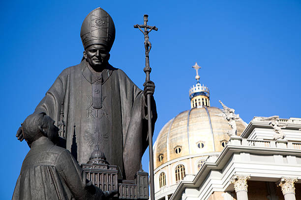 Lichen, Poland - October 3, 2010: Monument of Pope John Paul II in Lichea in Poland. Author Marian Konieczny (15 august 1999). Before of Pope kneels custodian of sanctuary with model of basilica