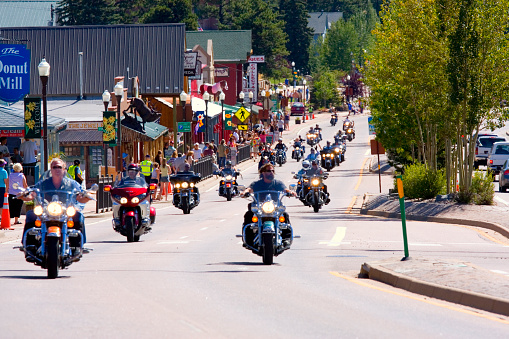 Woodland Park, Colorado, USA - August 20, 2011: Bikers ride westward on highway 24 in Woodland Park Colorado as part of a motorcycle parade to kick off the 19th annual Salute to American Veterans Rally