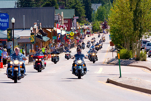 19th annual Salute to American Veterans Rally Woodland Park, Colorado, USA - August 20, 2011: Bikers ride westward on highway 24 in Woodland Park Colorado as part of a motorcycle parade to kick off the 19th annual Salute to American Veterans Rally woodland park zoo stock pictures, royalty-free photos & images