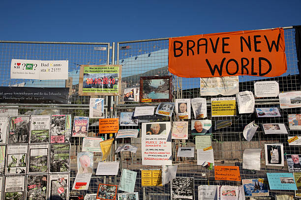 S21 protest at the construction fence brave new world Stuttgart, Germany - March 7, 2011: Protest against the planned new railway station S21. This image shows the construction fence directly at the gate to the railway station. german free democratic party photos stock pictures, royalty-free photos & images