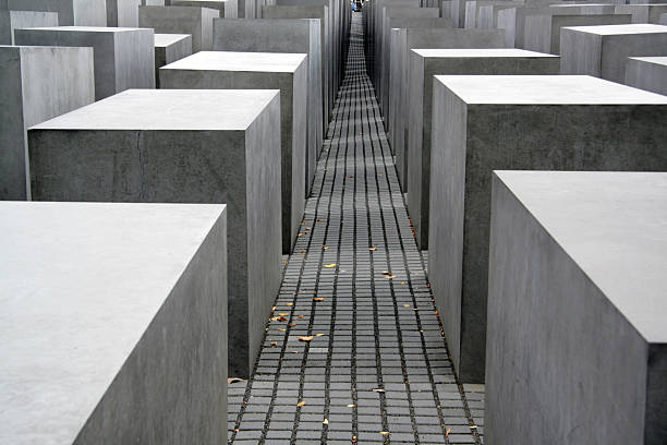 The Memorial to the Murdered Jews of Europe, also known as the Holocaust Memorial, is a memorial in Berlin to the Jewish victims of the Holocaust, designed by architect Peter Eisenman and Buro Happold. The image shows the memorial captured during spring season.