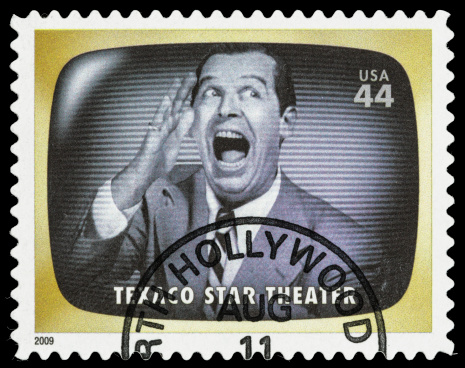 Sacramento, California, USA - June 8, 2012: A 2009 USA postage stamp with a photo of Milton Berle, host of the classic late 1940s and 1950s TV comedy/variety series , Texaco Star Theater.